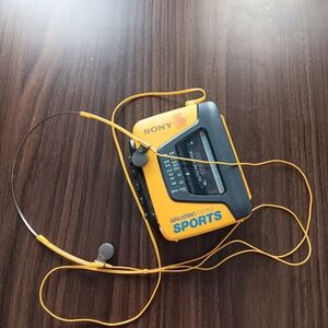 Sony Yellow Walkman Sports Portable Cassette Player with Yellow Headphones.